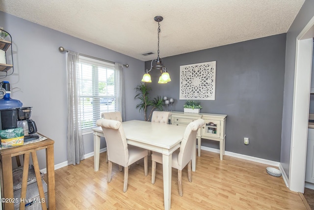 2505 Legend Dr, Wilmington, NC 28405 - dining room featuring light wood-type flooring and a textured ceiling