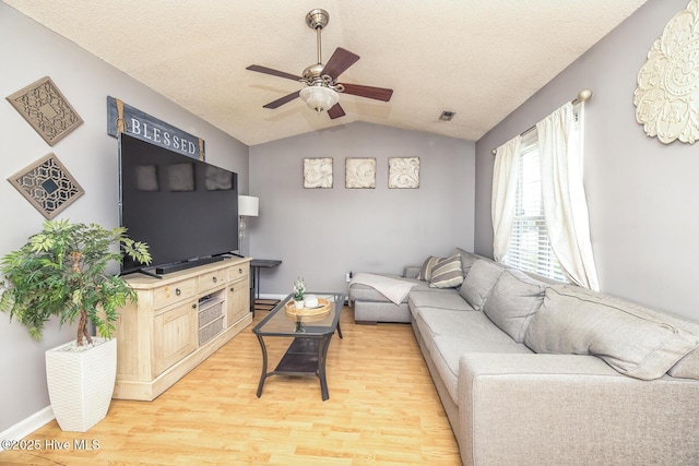 2505 Legend Dr, Wilmington, NC 28405 - living room featuring vaulted ceiling, ceiling fan, light wood-type flooring, and a textured ceiling