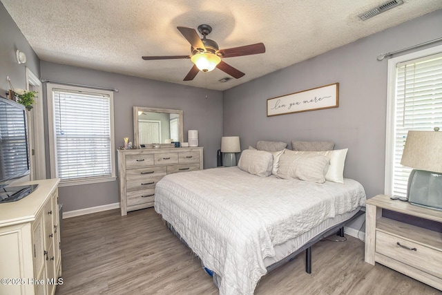 2505 Legend Dr, Wilmington, NC 28405 - bedroom with light wood finished floors, a textured ceiling, and a ceiling fan