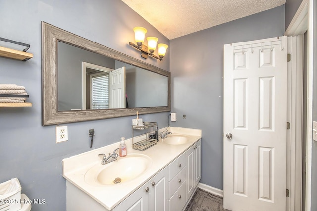 2505 Legend Dr, Wilmington, NC 28405 - bathroom featuring double vanity and a textured ceiling