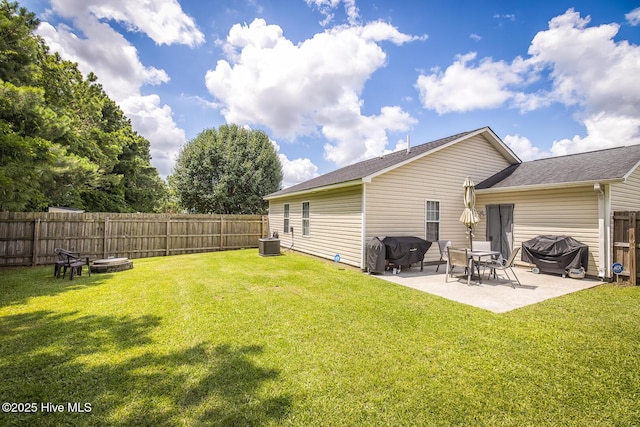 2505 Legend Dr, Wilmington, NC 28405 - back of house featuring a fenced backyard, a patio area, a shingled roof, and an outdoor fire pit