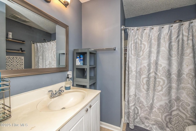 2505 Legend Dr, Wilmington, NC 28405 - bathroom with vanity, a textured ceiling, and a shower with shower curtain