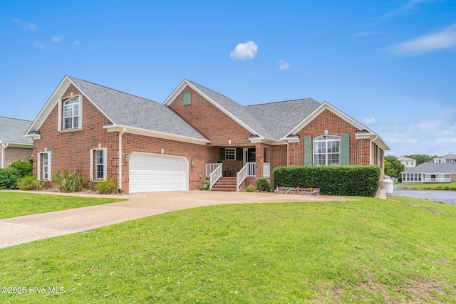 512 Shell Dr, Kure Beach, NC 28449 - traditional-style house featuring a front yard, brick siding, and an attached garage