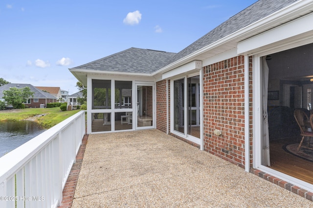 512 Shell Dr, Kure Beach, NC 28449 - view of patio / terrace featuring a sunroom and a water view