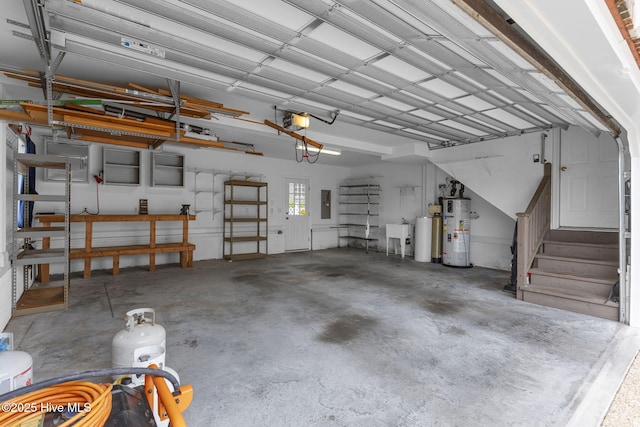 512 Shell Dr, Kure Beach, NC 28449 - garage with gas water heater, a garage door opener, and electric panel