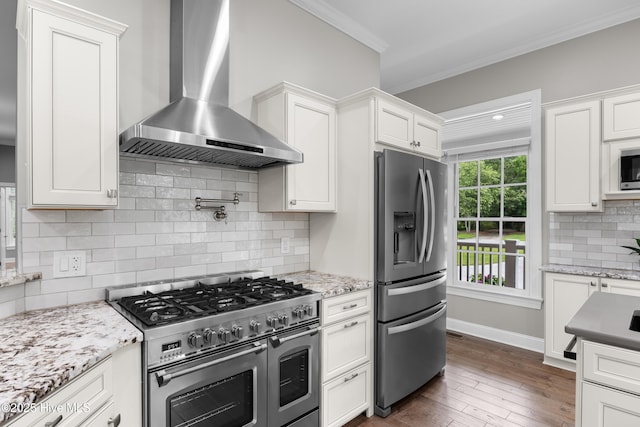 376 Red Fox Run Dr, Wallace, NC 28466 - kitchen featuring stainless steel appliances, wall chimney exhaust hood, crown molding, tasteful backsplash, and white cabinetry