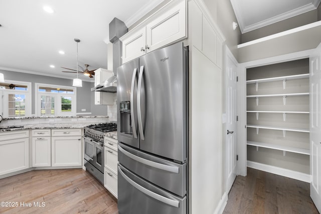 376 Red Fox Run Dr, Wallace, NC 28466 - kitchen with stainless steel appliances, crown molding, light wood-type flooring, white cabinets, and recessed lighting