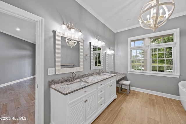 376 Red Fox Run Dr, Wallace, NC 28466 - bathroom with a chandelier, ornamental molding, double vanity, and wood finished floors