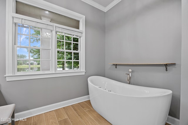 376 Red Fox Run Dr, Wallace, NC 28466 - bathroom featuring a freestanding tub, ornamental molding, and wood finished floors