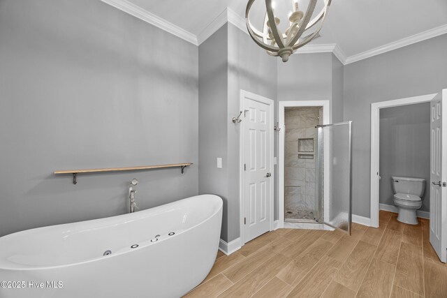 376 Red Fox Run Dr, Wallace, NC 28466 - bathroom with a chandelier, a freestanding bath, a stall shower, ornamental molding, and wood finished floors