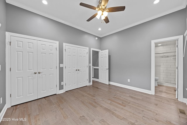 376 Red Fox Run Dr, Wallace, NC 28466 - unfurnished bedroom with multiple closets, crown molding, light wood-style floors, ensuite bathroom, and recessed lighting