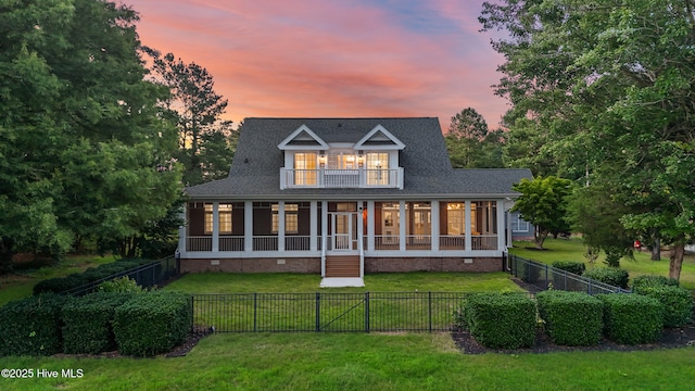 376 Red Fox Run Dr, Wallace, NC 28466 - back of property at dusk featuring crawl space, a balcony, a fenced backyard, and a sunroom