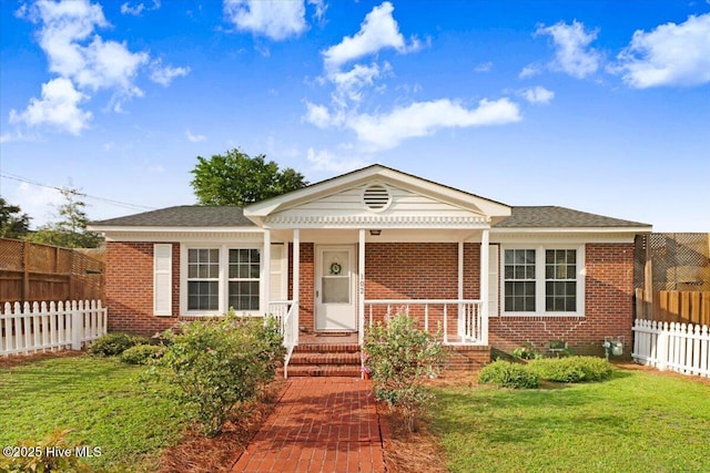 102 SE Third St, Snow Hill, NC 28580 - view of front of home with brick siding, covered porch, and a shingled roof