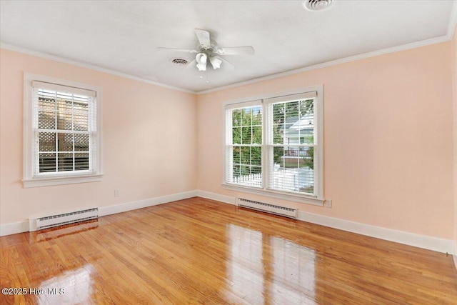 102 SE Third St, Snow Hill, NC 28580 - unfurnished room with a baseboard heating unit, wood finished floors, crown molding, and ceiling fan