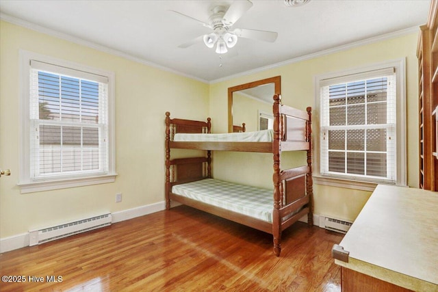 102 SE Third St, Snow Hill, NC 28580 - bedroom featuring a baseboard heating unit, light wood-style floors, ornamental molding, and ceiling fan