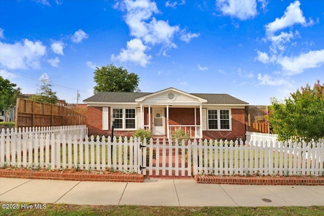 102 SE Third St, Snow Hill, NC 28580 - view of front of home with a porch, brick siding, and a fenced front yard