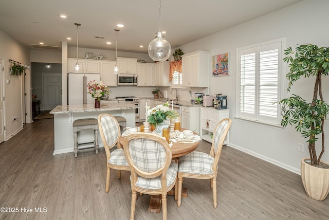 9363 Eagle Ridge Dr, Calabash, NC 28467 - dining area with light wood-style flooring and recessed lighting