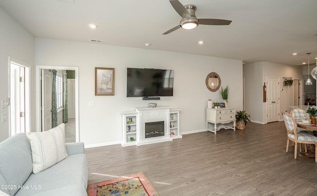 9363 Eagle Ridge Dr, Calabash, NC 28467 - living area with wood finished floors, a ceiling fan, a fireplace, and recessed lighting