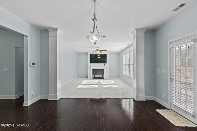 109 Creek End Ct, Swansboro, NC 28584 - unfurnished living room with decorative columns, a ceiling fan, a glass covered fireplace, and hardwood / wood-style floors