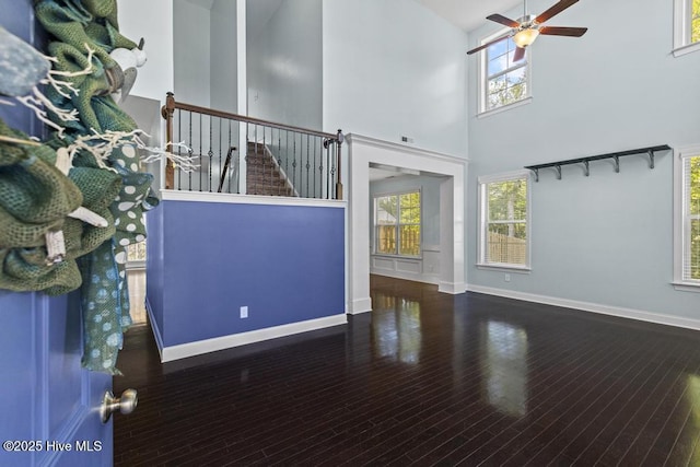 109 Creek End Ct, Swansboro, NC 28584 - unfurnished living room featuring a ceiling fan, a high ceiling, healthy amount of natural light, and wood finished floors