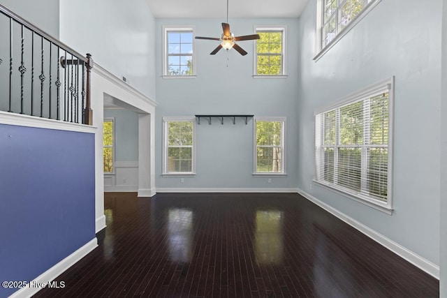 109 Creek End Ct, Swansboro, NC 28584 - unfurnished living room featuring ceiling fan, a high ceiling, and hardwood / wood-style flooring
