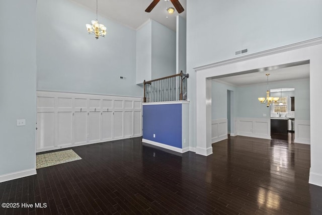 109 Creek End Ct, Swansboro, NC 28584 - unfurnished living room with a chandelier, a decorative wall, high vaulted ceiling, ceiling fan, and crown molding