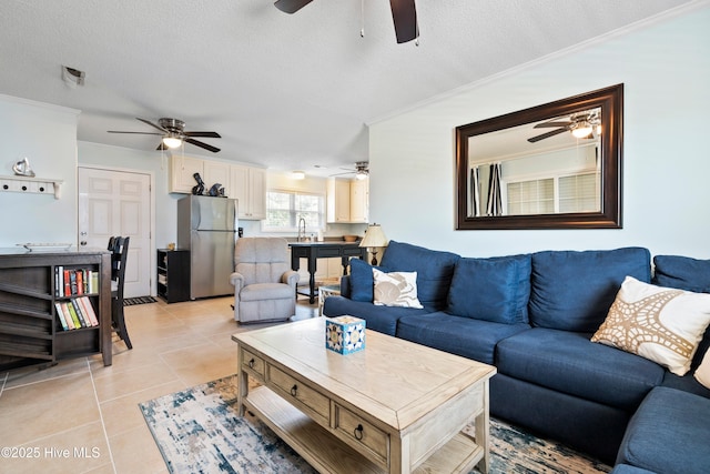 316 E Dolphin Dr, Oak Island, NC 28465 - living area featuring a ceiling fan, light tile patterned floors, ornamental molding, and a textured ceiling