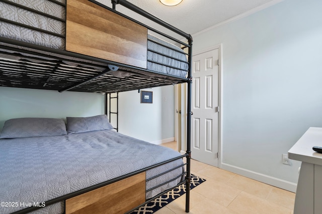 316 E Dolphin Dr, Oak Island, NC 28465 - bedroom featuring ornamental molding and tile patterned flooring