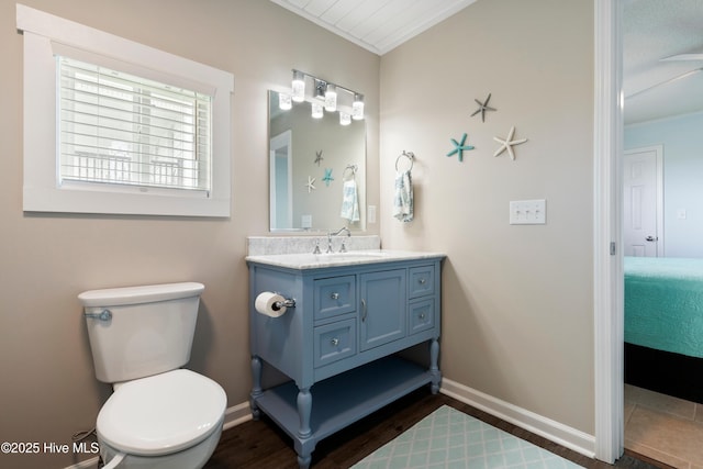 316 E Dolphin Dr, Oak Island, NC 28465 - ensuite bathroom with vanity, crown molding, and wood finished floors