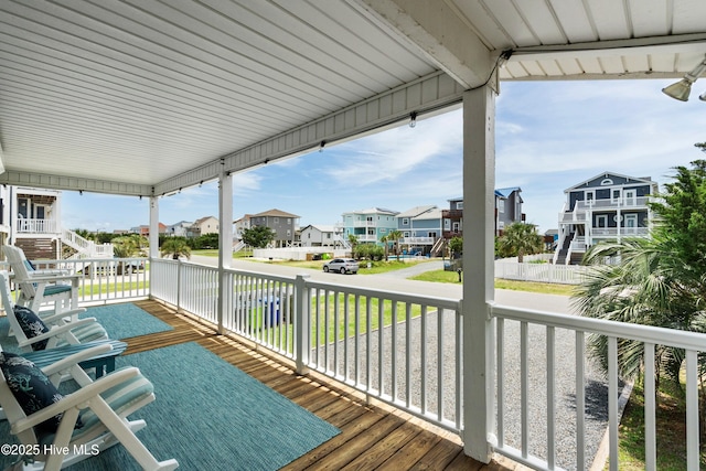 316 E Dolphin Dr, Oak Island, NC 28465 - porch featuring a residential view and a yard