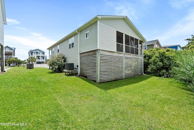 316 E Dolphin Dr, Oak Island, NC 28465 - rear view of house with a yard and a sunroom