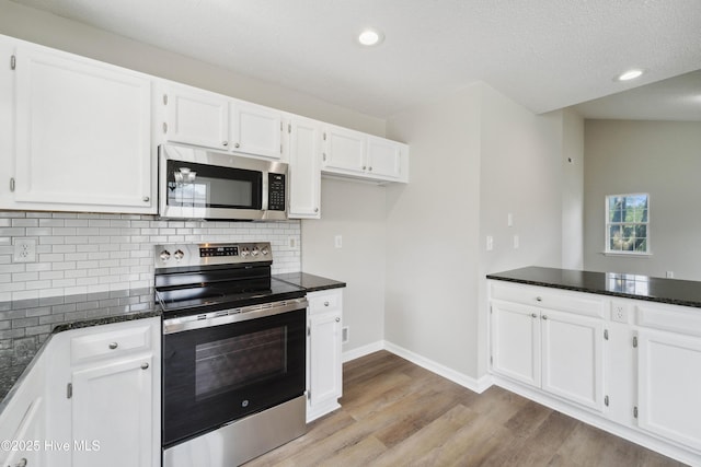 802 Mayfield Ct, Wilmington, NC 28411 - kitchen with stainless steel appliances, white cabinetry, backsplash, light wood finished floors, and recessed lighting