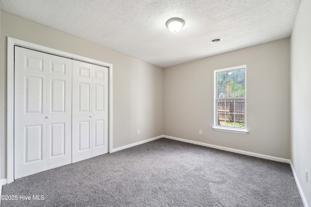 802 Mayfield Ct, Wilmington, NC 28411 - unfurnished bedroom featuring carpet flooring, a textured ceiling, and a closet