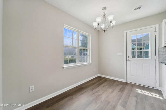 802 Mayfield Ct, Wilmington, NC 28411 - unfurnished dining area with a chandelier and wood finished floors