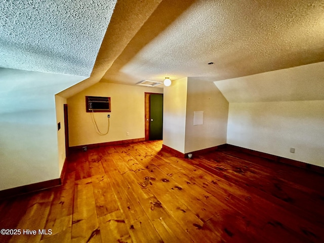 9550 NC-171, Williamston, NC 27892 - additional living space featuring hardwood / wood-style floors, a textured ceiling, lofted ceiling, and a wall unit AC