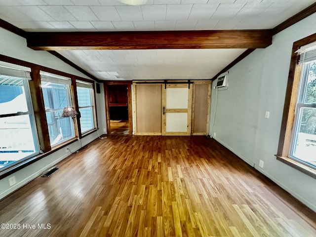 9550 NC-171, Williamston, NC 27892 - unfurnished living room featuring wood finished floors and a wall mounted AC