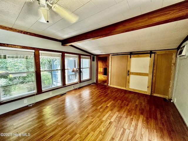 9550 NC-171, Williamston, NC 27892 - unfurnished bedroom featuring wood finished floors and a barn door