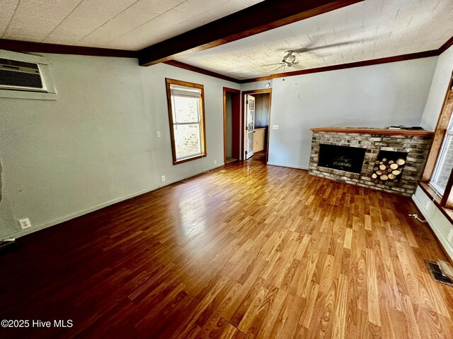 9550 NC-171, Williamston, NC 27892 - unfurnished living room featuring crown molding, wood finished floors, a brick fireplace, a wall mounted air conditioner, and a ceiling fan