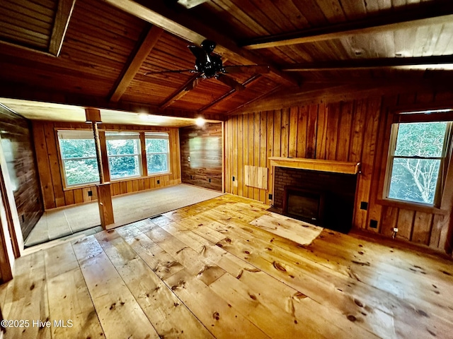 9550 NC-171, Williamston, NC 27892 - unfurnished living room featuring hardwood / wood-style flooring, wood walls, wood ceiling, healthy amount of natural light, and a brick fireplace