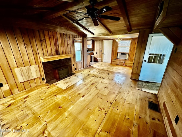 9550 NC-171, Williamston, NC 27892 - unfurnished living room with wooden walls, wood-type flooring, healthy amount of natural light, ceiling fan, and wooden ceiling