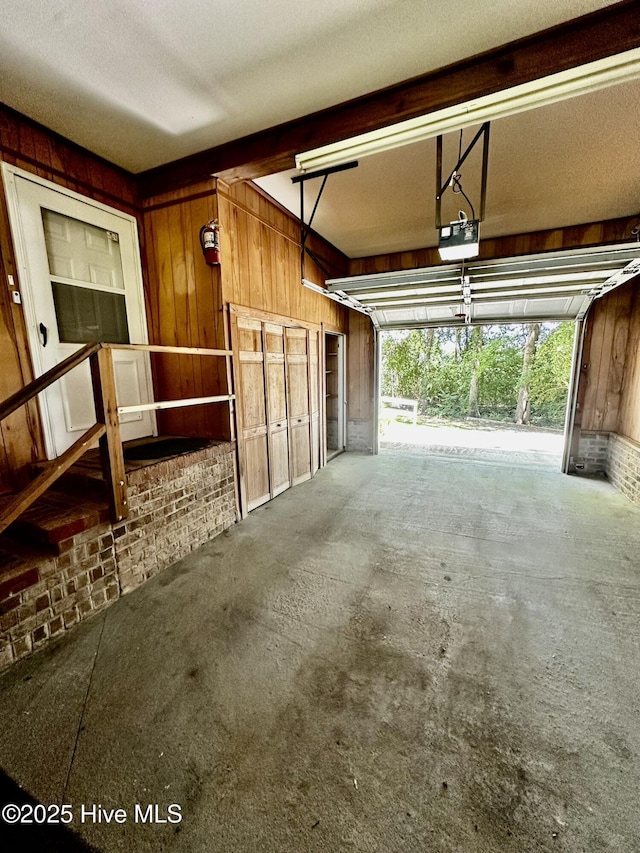 9550 NC-171, Williamston, NC 27892 - garage featuring a garage door opener and wooden walls