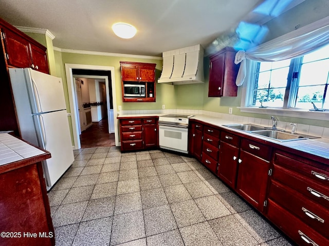 9550 NC-171, Williamston, NC 27892 - kitchen with white appliances, custom range hood, crown molding, tile countertops, and dark brown cabinets