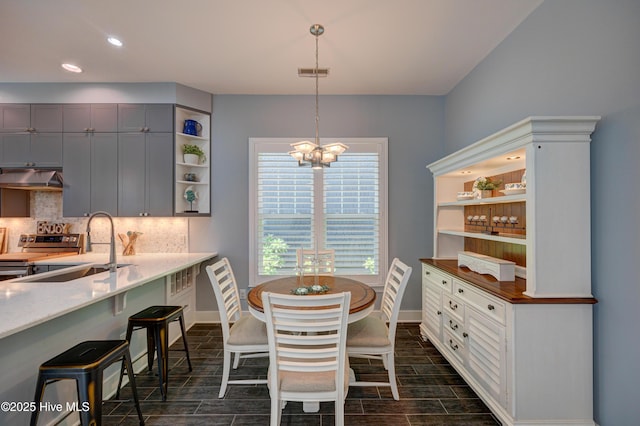 8508 Hammock Dunes Dr, Wilmington, NC 28411 - dining room with a chandelier, wood tiled floors, and recessed lighting
