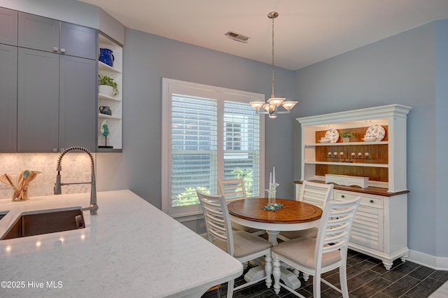 8508 Hammock Dunes Dr, Wilmington, NC 28411 - dining area featuring a chandelier and dark wood-type flooring