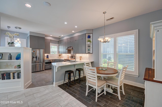8508 Hammock Dunes Dr, Wilmington, NC 28411 - dining room featuring a chandelier, wood tiled floors, and recessed lighting
