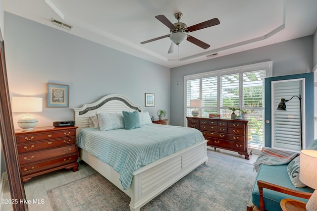 8508 Hammock Dunes Dr, Wilmington, NC 28411 - bedroom featuring a raised ceiling and a ceiling fan