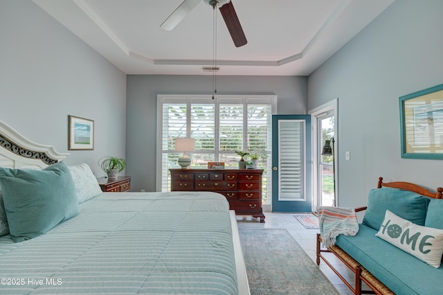 8508 Hammock Dunes Dr, Wilmington, NC 28411 - bedroom featuring access to exterior, a tray ceiling, and ceiling fan