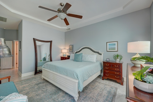 8508 Hammock Dunes Dr, Wilmington, NC 28411 - bedroom featuring a raised ceiling and ceiling fan