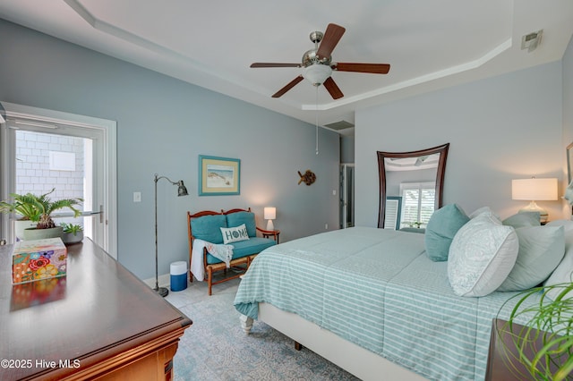 8508 Hammock Dunes Dr, Wilmington, NC 28411 - bedroom with a tray ceiling and a ceiling fan