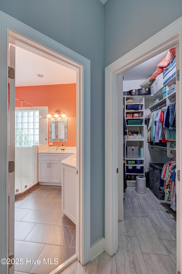 8508 Hammock Dunes Dr, Wilmington, NC 28411 - full bathroom featuring vanity, a spacious closet, and a stall shower
